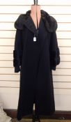 1930's black wool coat labelled 'Bradleys, Chepstow Place, London, W2', the sleeves serve as a cape,