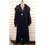 1930's black wool coat labelled 'Bradleys, Chepstow Place, London, W2', the sleeves serve as a cape,