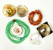 Quantity of costume jewellery to include a glass necklace, amber-style beads, compacts,