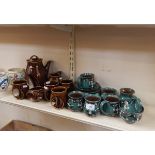 Holkham pottery coffee service decorated in brown glaze, with integral handles,