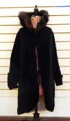 Black velvet knee-length opera cloak with quilted and fur stand-up collar,