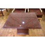 Contemporary red granite occasional table, bevelled edge, on pedestal granite base,