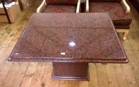 Contemporary red granite occasional table, bevelled edge, on pedestal granite base,