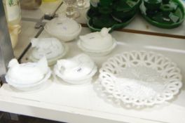 Four white pressed glass butter dishes and covers with animal covers, comprising a cow, a horse,