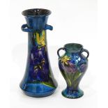 Quantity of Torquay pottery with blue ground and handpainted irises to comprise vases, plates, etc.