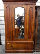 Victorian mahogany wardrobe, the mirror door enclosing hanging space, with a long drawer below,