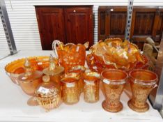 Quantity of carnival glass including punch bowls, fruit bowls, water jug with matching tumblers,