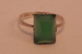 Silver dress ring set with a single rectangular dyed green chalcedony