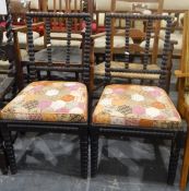 Pair of 19th century ebonised bobbin turned dining chairs with cushioned seats