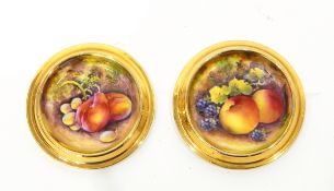 Pair of Royal Worcester porcelain coasters with circular stepped gilt rim,