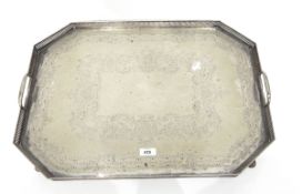 Silver plate octagonal tray with open fretwork border, foliate engraving, raised on scroll feet,