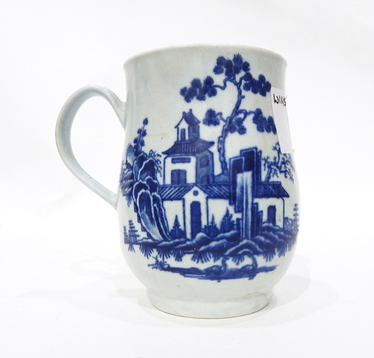 18th century Worcester mug of baluster form decorated in underglaze blue with bamboo and fence,