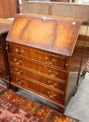 Mahogany bureau with fitted interior, four long graduated drawers below, on bracket feet,