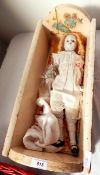 Wooden doll's crib with china composition headed doll and china composition feet (one arm separated