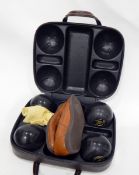 Set of Cotswold Goldline lawn bowls and shoes in case