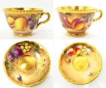 Pair of late 20th century Royal Worcester porcelain cups and saucers, shaped gilt rims and handles,