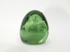 Victorian large green glass dump paperweight with internal decoration of a figure seated on an