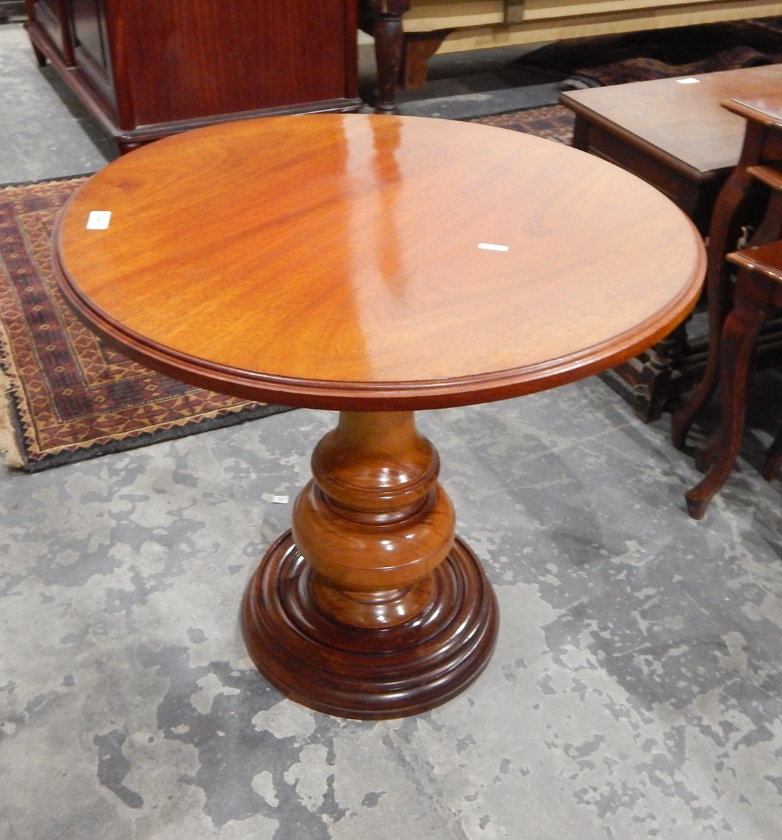 Mahogany circular top side table on turned bulbous pedestal and circular foot,