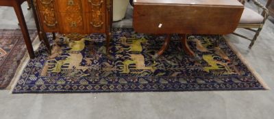 Handmade Afghan belouch rug with blue ground, central field with animals including deer, etc.