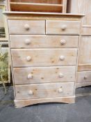Limed-effect chest of two short and three long graduated drawers and an open bookcase of five
