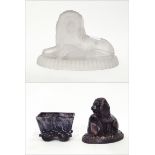 Victorian purple slag glass lion ornament, the lion supported by a shield, on oval base, 17cm long,