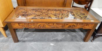 Chinese coffee table of rectangular form with a central panel carved in deep relief with figures,