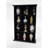 Black collectors shelf unit and contents of 12 modern Japanese miniature porcelain vases and a pair