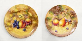 Pair of 20th century Royal Worcester porcelain plates with gilt rim,