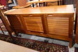 Modern hardwood side cabinet with three louvred doors, raised on square feet,