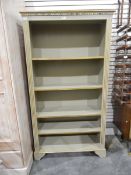 Grey painted open bookcase of four shelves, raised on bracket feet,