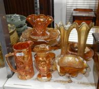 Quantity of orange carnival glass including comport, jug, pair of fluted vases, etc.