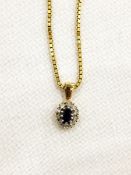 Sapphire and diamond oval pendant on a link chain necklace