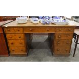 Victorian oak partner's pedestal desk with an arrangement of nine short drawers to each side,