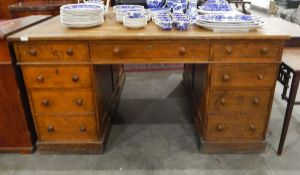 Victorian oak partner's pedestal desk with an arrangement of nine short drawers to each side,