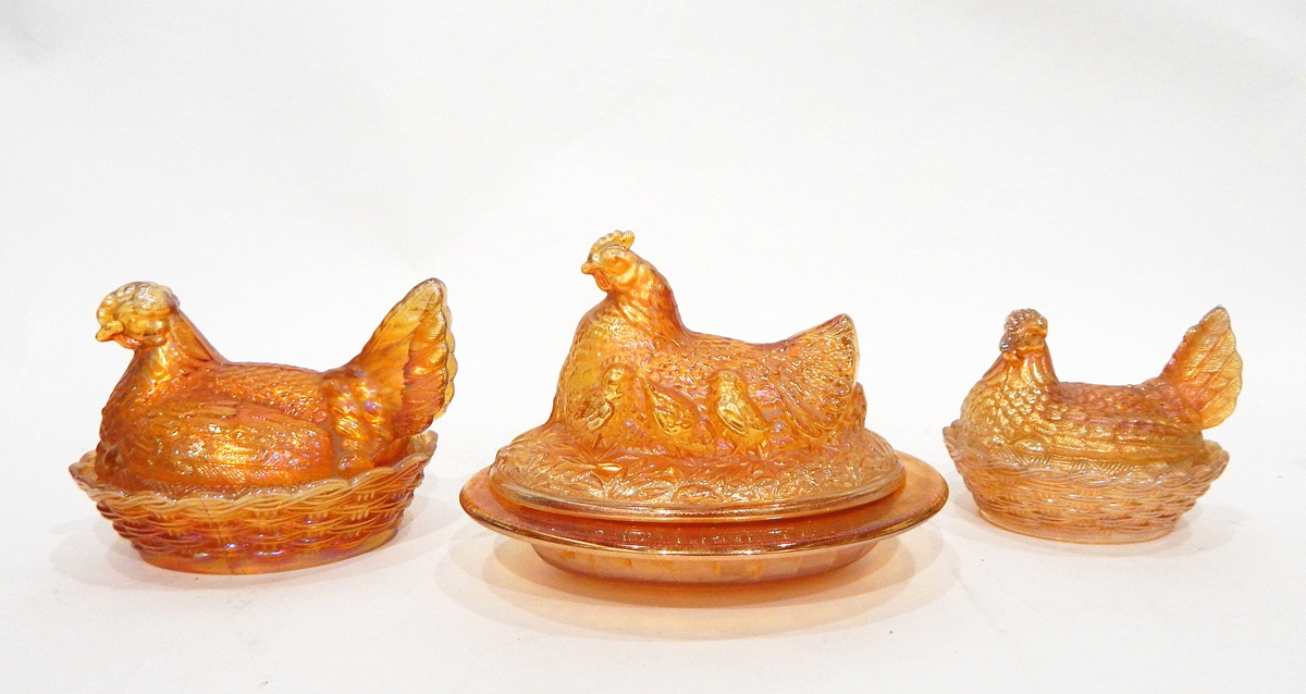 Pair of marigold carnival glass butter dishes, of oval form,