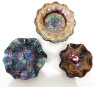 Collection of carnival glass dishes, mainly black and amethyst glass, including a pair of bowls,