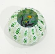 Glass paperweight by John Deacons of circular form with green and white millefiori cane outer layer,