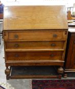 Oak bureau with fitted interior, three graduated long drawers,