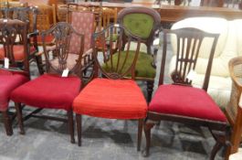 Two Hepplewhite-style mahogany shield-back dining chairs with pierced splats,