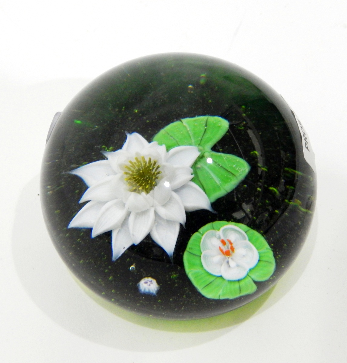 Limited edition glass paperweight by Baccarat of circular domed form depicting a water lily flower