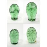 Pair of Victorian green glass dump paperweights decorated internally with flowers,