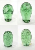 Pair of Victorian green glass dump paperweights decorated internally with flowers,