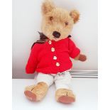 Chad Valley plush bear wearing dungarees with a red knitted cardigan and with military buttons,