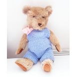 1930's/40's plush bear with plastic eyes and dressed in blue knitted jump suit