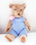 1930's/40's plush bear with plastic eyes and dressed in blue knitted jump suit