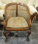 Beech framed bergere tub chair with cane back and panel seat,