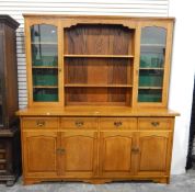 Pale oak kitchen dresser, the rack with a pair of glazed cupboards and two central open shelves,