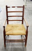 Old child's beech armchair with bar back, rush seat,