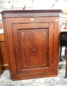 George III oak and boxwood inlaid corner cupboard with inlaid cornice,