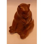 Black Forest-style carved wooden model of a seated bear,